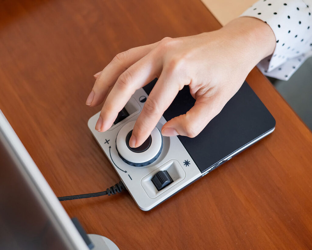 Person using a specialized trackball interface to use a website with a slider